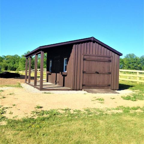 10 x 20 high board and batten with double doors and a 6 foot side porch.