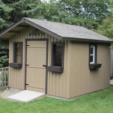 10 x 10 high board and batten with a 2 foot gable overhang.