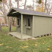 10 x 14 high board and batten with a 4 foot gable porch.
