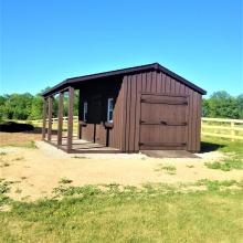10 x 20 high board and batten with double doors and a 6 foot side porch.